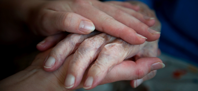 Holding-hands-comforting-an-elderly-lady